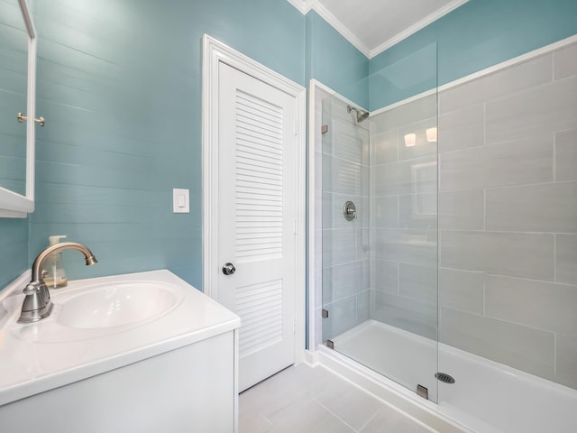 bathroom featuring walk in shower, ornamental molding, and vanity