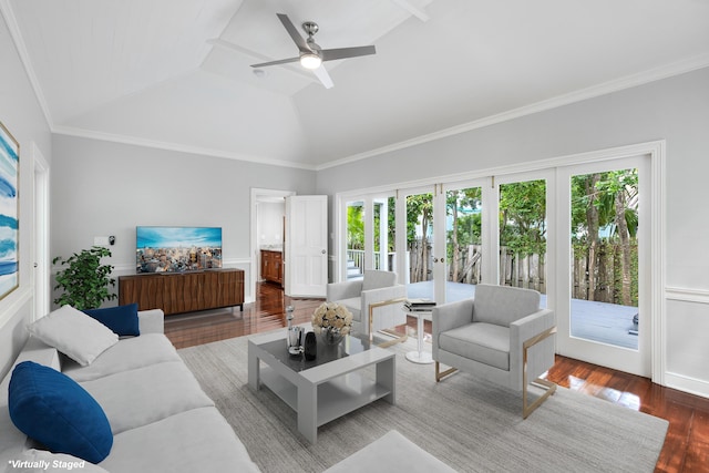 living room featuring vaulted ceiling, hardwood / wood-style flooring, ornamental molding, ceiling fan, and french doors