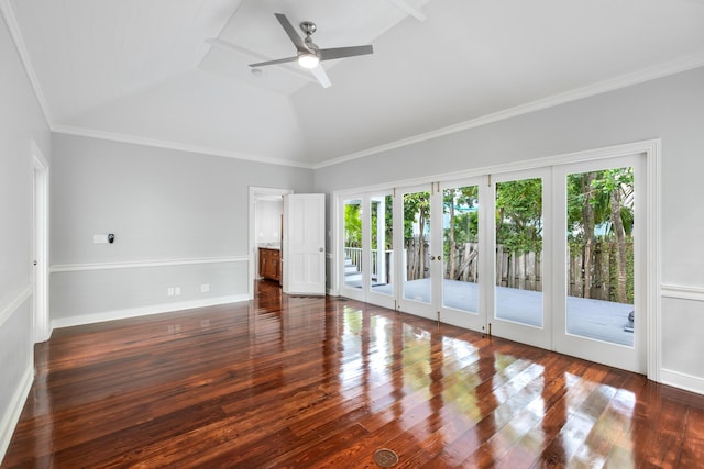 empty room with dark wood-type flooring, ornamental molding, ceiling fan, and vaulted ceiling