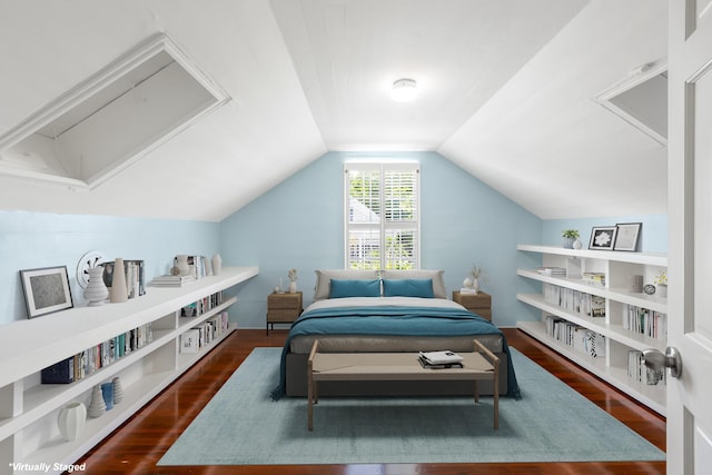 bedroom with dark hardwood / wood-style floors and vaulted ceiling