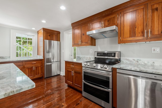 kitchen with stainless steel appliances, light stone countertops, and dark wood-type flooring