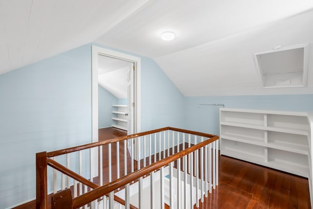 hall featuring lofted ceiling and dark wood-type flooring