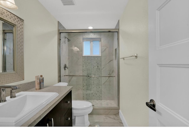 bathroom featuring a shower with door, vanity, and toilet