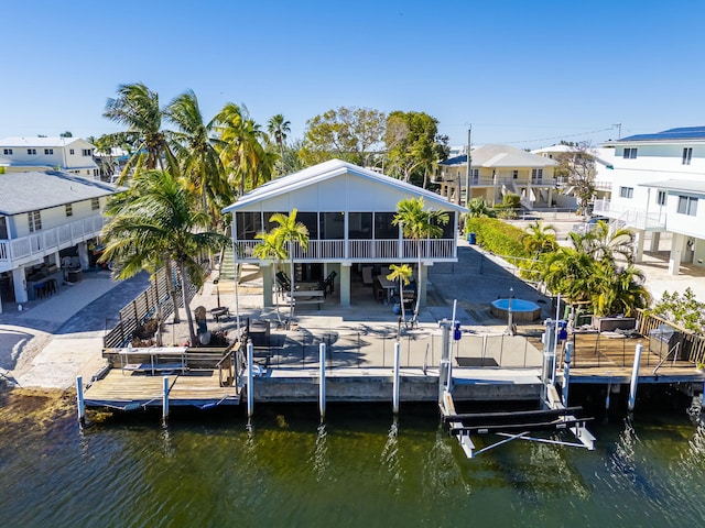 dock area featuring a patio and a water view