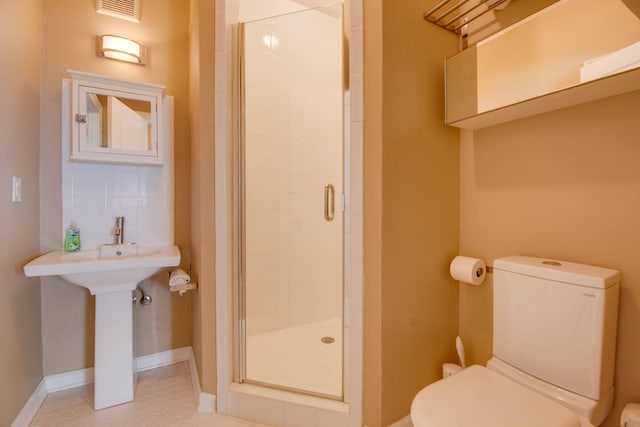 bathroom with tile patterned flooring, an enclosed shower, and toilet