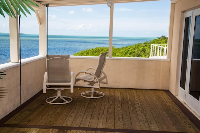 unfurnished sunroom with a water view