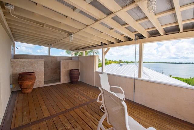 wooden deck featuring a water view