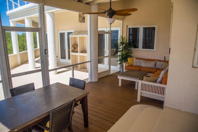 sunroom / solarium featuring ceiling fan