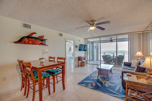 1901 S Roosevelt Blvd Unit 404S, Key West, FL 33040 - living room featuring visible vents, ceiling fan, a textured ceiling, and expansive windows