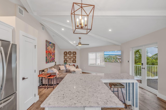 273 Indies Rd, Ramrod, FL 33042 - kitchen with freestanding refrigerator, light wood finished floors, a kitchen island, white cabinetry, and a chandelier