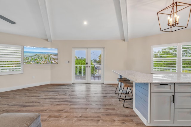 273 Indies Rd, Ramrod, FL 33042 - kitchen with plenty of natural light, light stone counters, french doors, and a breakfast bar