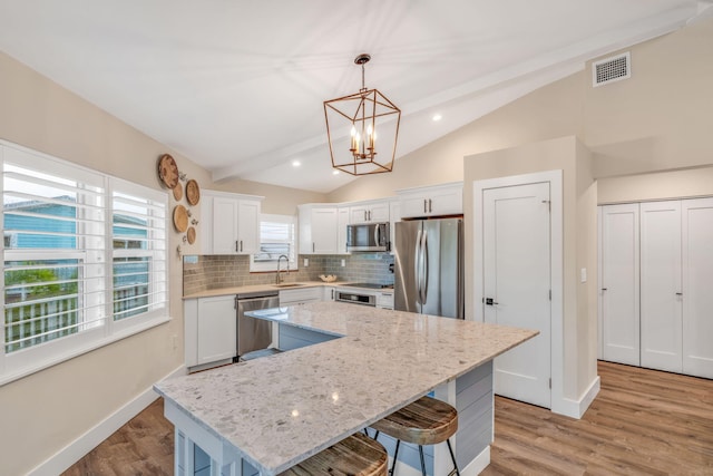 273 Indies Rd, Ramrod, FL 33042 - kitchen featuring stainless steel appliances, vaulted ceiling, a chandelier, a kitchen island, and tasteful backsplash