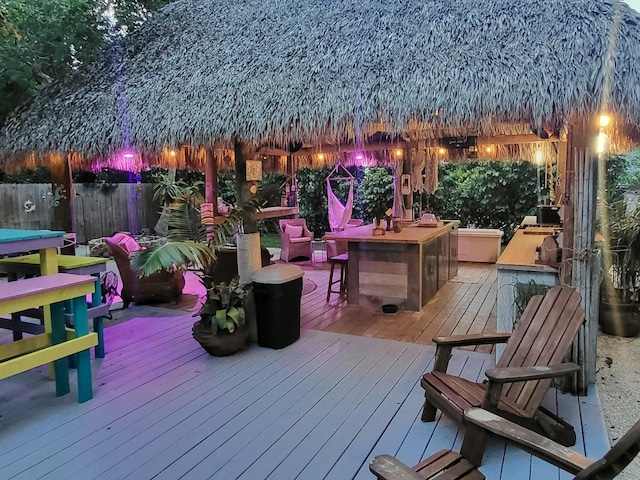 wooden terrace with a gazebo and exterior bar