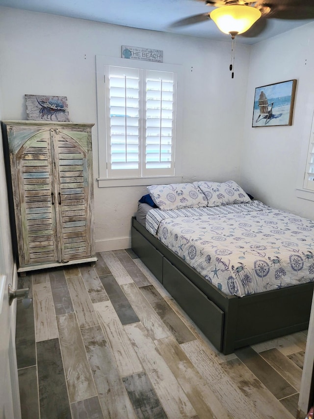 bedroom with ceiling fan and hardwood / wood-style floors