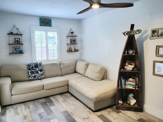 living room featuring ceiling fan and light hardwood / wood-style floors