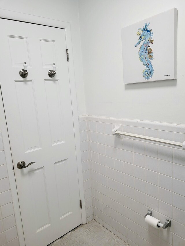 bathroom with tile walls