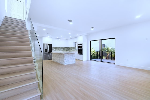 kitchen featuring visible vents, decorative backsplash, appliances with stainless steel finishes, white cabinets, and modern cabinets