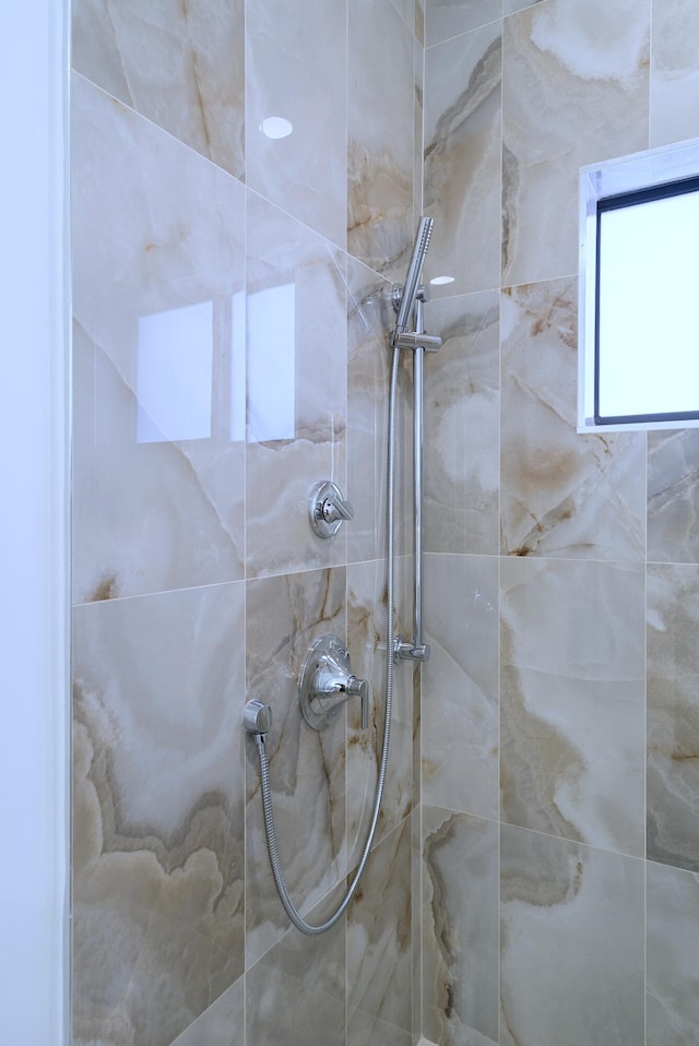 bathroom with a tile shower