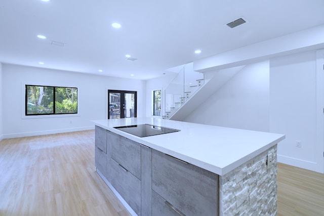 kitchen with recessed lighting, black electric stovetop, light wood-style floors, and modern cabinets