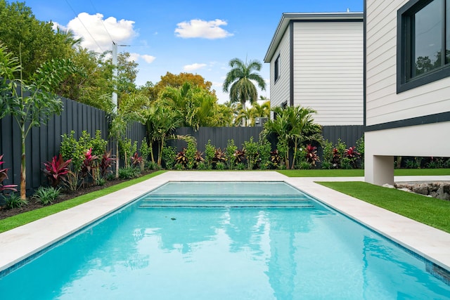 view of swimming pool featuring a fenced in pool, a yard, and a fenced backyard