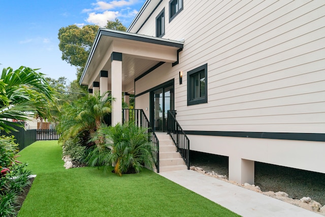 view of side of property featuring a yard and fence