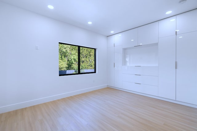 unfurnished room featuring recessed lighting, baseboards, and light wood finished floors