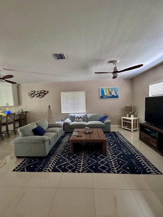 living room with ceiling fan and tile patterned flooring