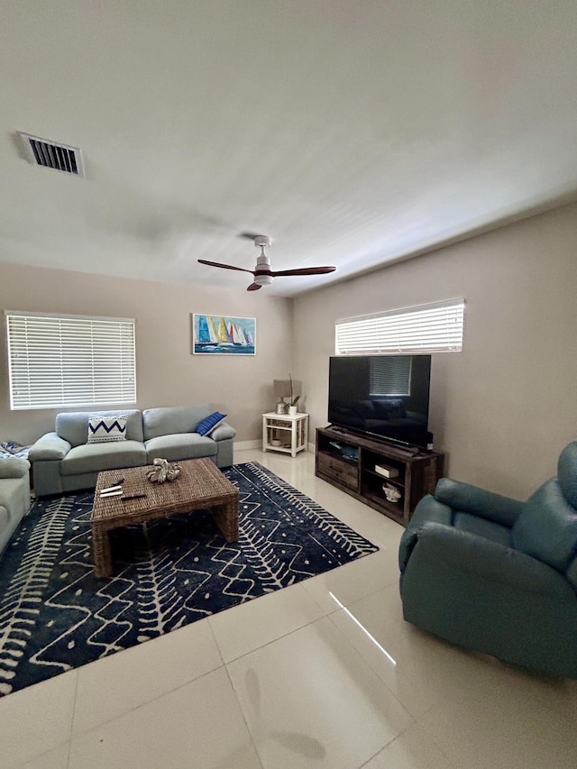 living room featuring ceiling fan and tile patterned flooring