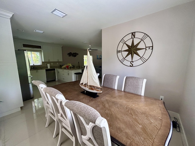 tiled dining room with sink