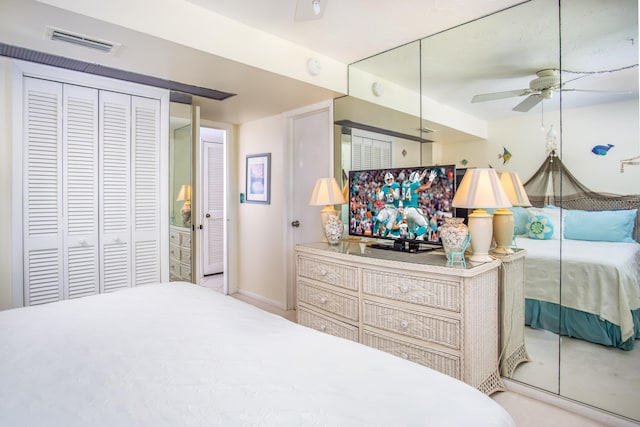 bedroom with a closet, a ceiling fan, and visible vents