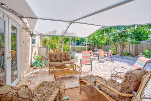 60 Bahama Ave, Key Largo, FL 33037 - view of patio / terrace with outdoor lounge area, outdoor dining area, and a fenced backyard