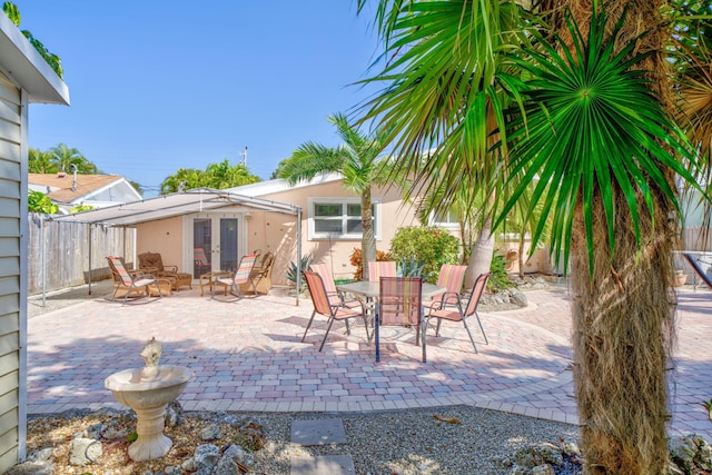 60 Bahama Ave, Key Largo, FL 33037 - view of patio / terrace with outdoor dining space, french doors, and fence