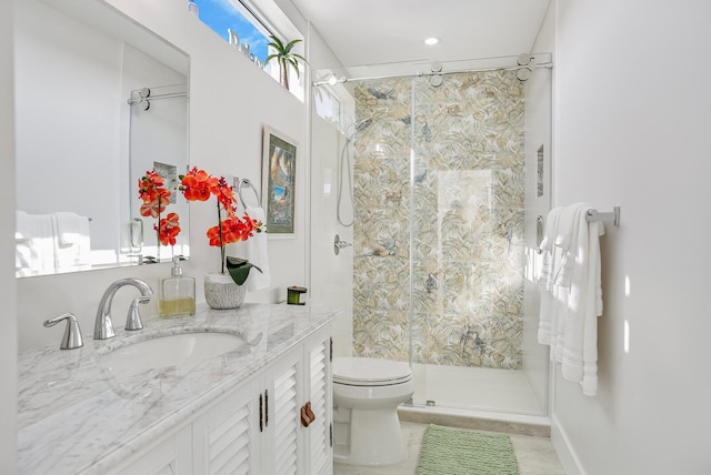 bathroom featuring vanity, toilet, and a shower with shower door