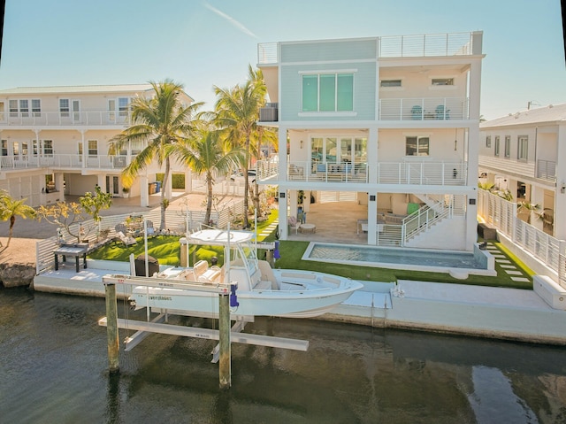 rear view of house with a pool and a patio area