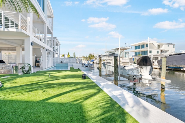 view of dock featuring a yard and a water view