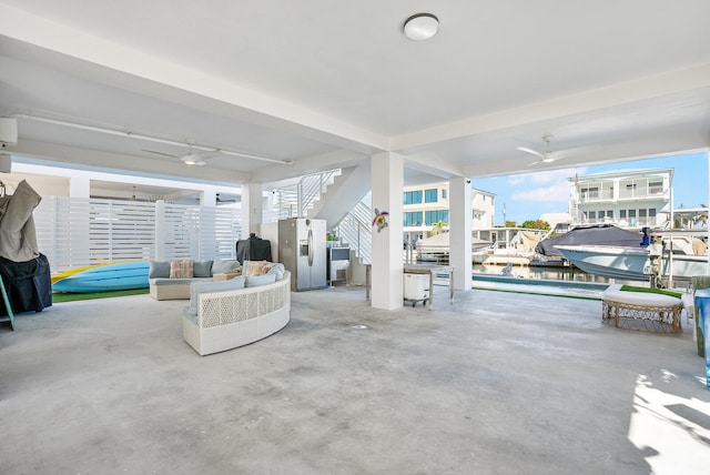 view of patio / terrace with a water view, an outdoor hangout area, and ceiling fan