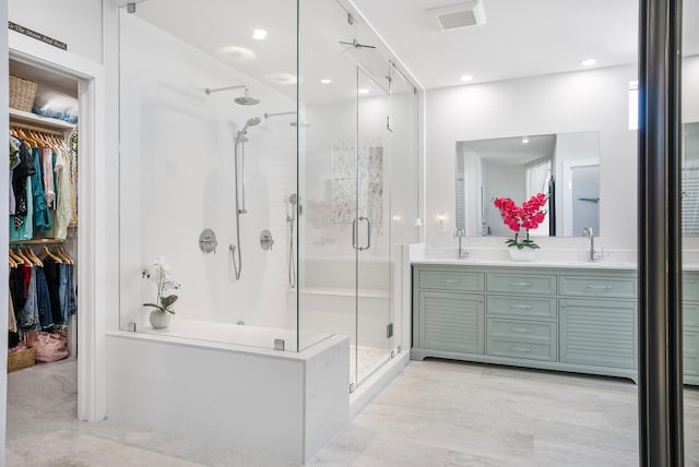 bathroom with vanity and a shower with shower door