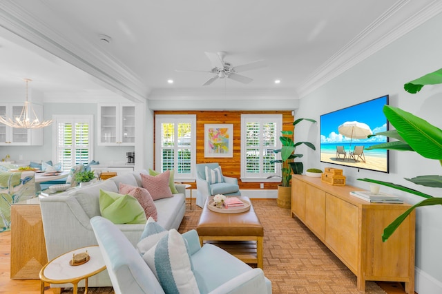 living room with ceiling fan with notable chandelier, recessed lighting, and crown molding