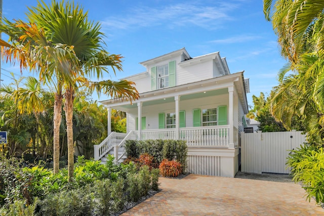 view of front of house with covered porch and a gate