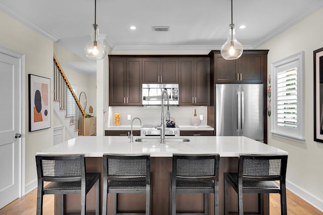 205 Virginia St, Key West, FL 33040 - kitchen with stainless steel appliances, crown molding, dark brown cabinetry, light countertops, and decorative backsplash