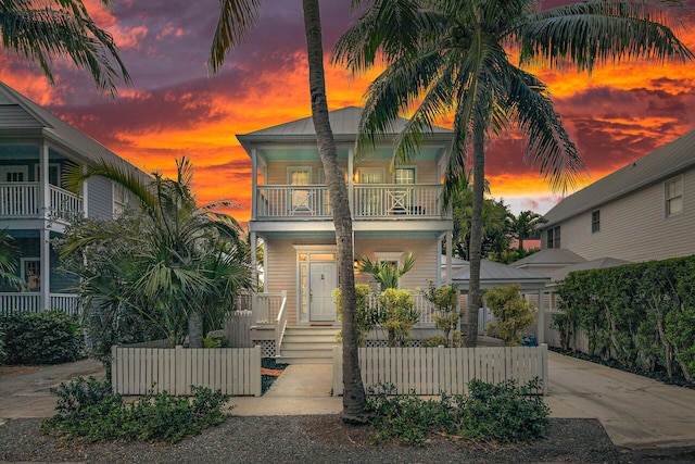 view of front of property featuring a balcony and a porch