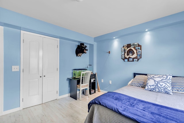 bedroom featuring light hardwood / wood-style floors and a closet