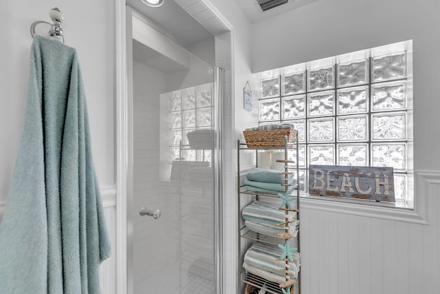 bathroom with a shower with shower door