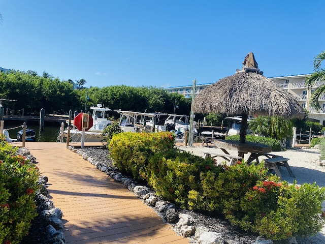 view of property's community featuring a water view and a boat dock