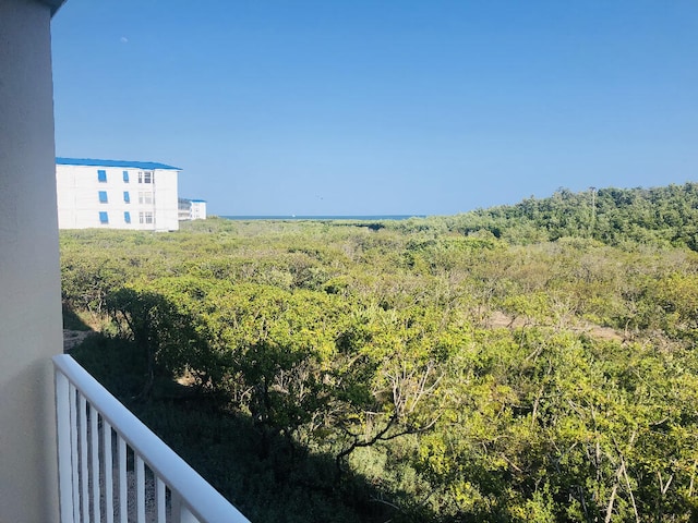 balcony featuring a forest view