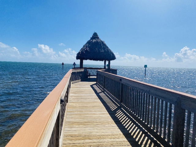 view of dock featuring a gazebo and a water view