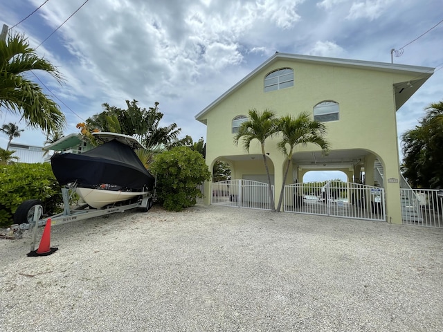 1165 Lagoon Dr, Summerland, FL 33042 - view of parking with fence, gravel driveway, and a carport