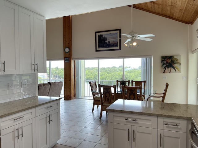 1165 Lagoon Dr, Summerland, FL 33042 - kitchen featuring ceiling fan, high vaulted ceiling, light tile patterned floors, white cabinetry, and decorative backsplash