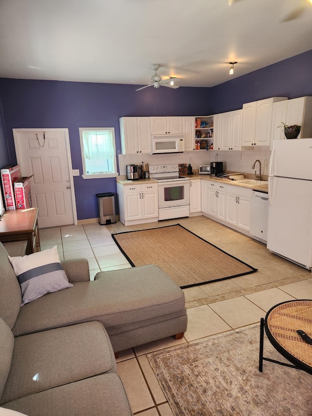 living room with sink, light tile patterned floors, and ceiling fan