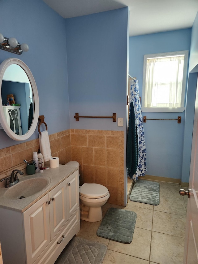 bathroom featuring tile walls, a shower with shower curtain, vanity, tile patterned floors, and toilet